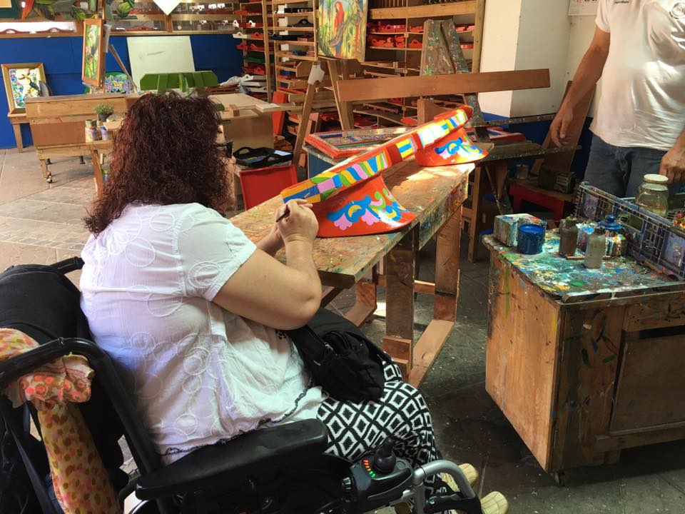 Woman in a wheelchair painting