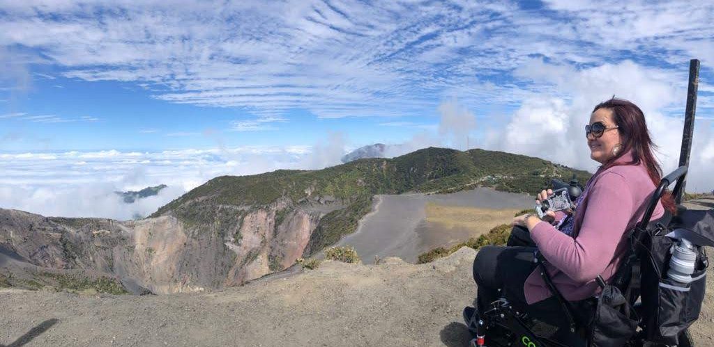 Lady in electric wheelchair looking at the crater of Irazú Volcano